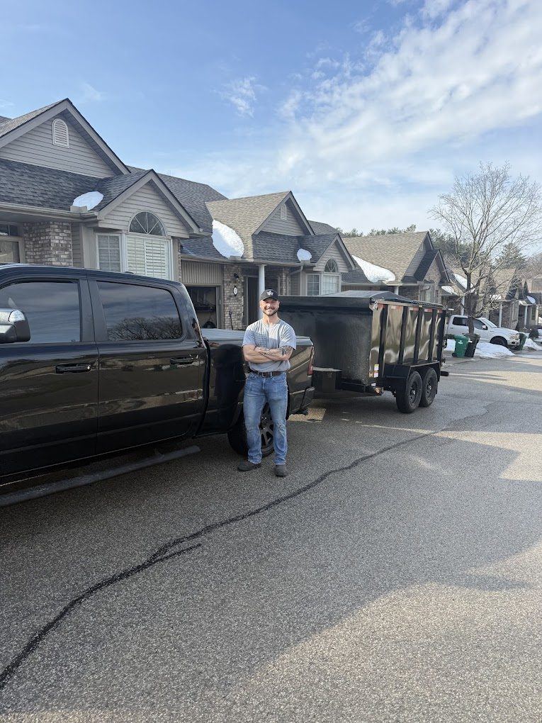 Alex Metzger, owner and operator of All-Star Junk Removal, with the truck and trailer
