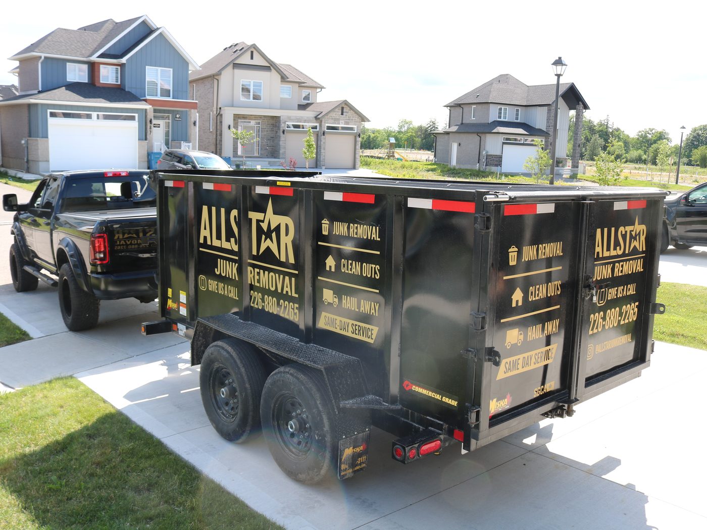 All-Star Junk Removal trailer loaded with items outside a home